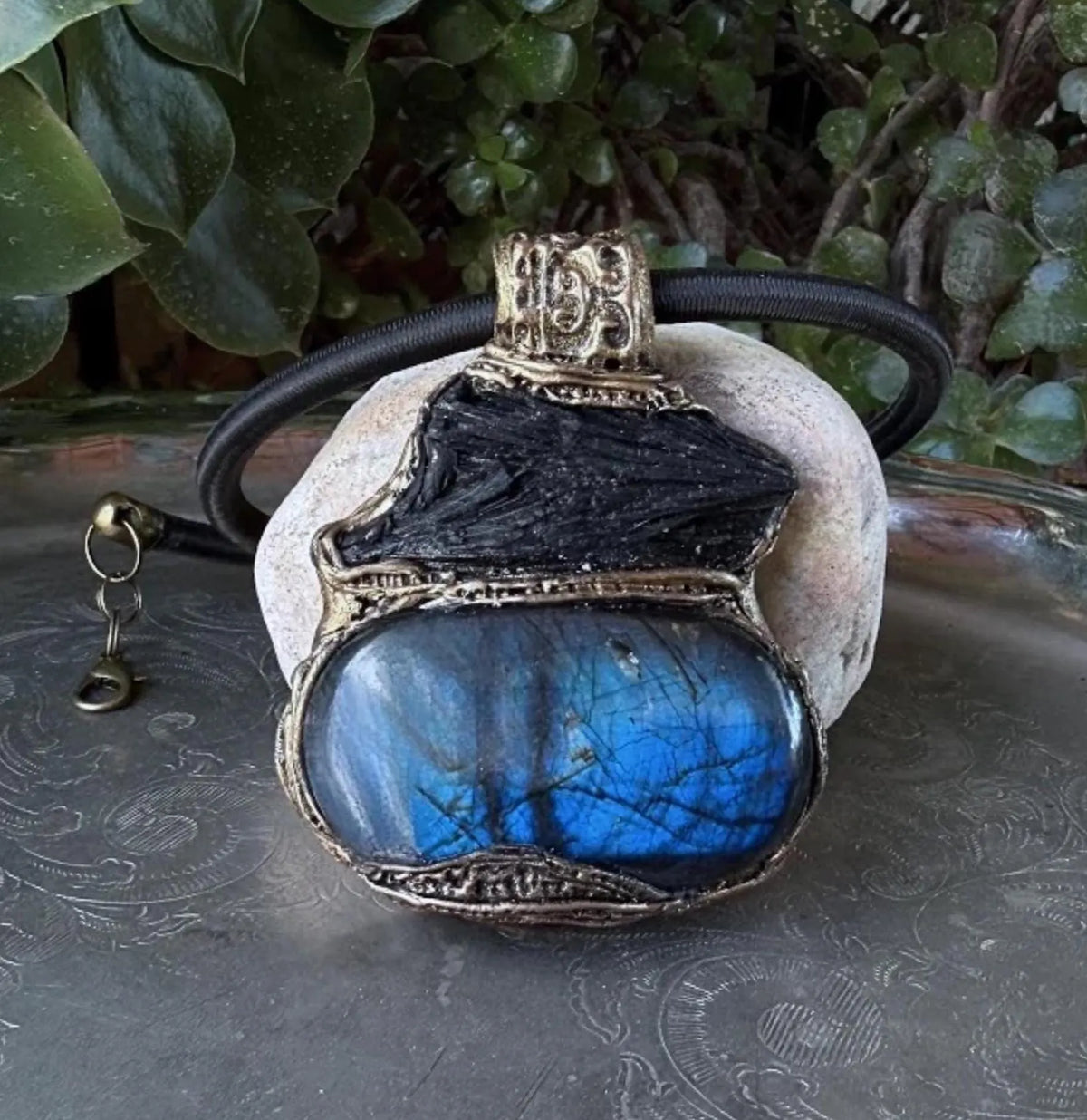 Large Labradorite and Black Kyanite pendant choker worn on a model, featuring raw black crystal above a polished blue-flash Labradorite in an ornate bronze-tone setting.