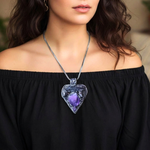 Sculptural heart pendant necklace with central purple Amethyst, dark textured setting and polished Hematite stones.