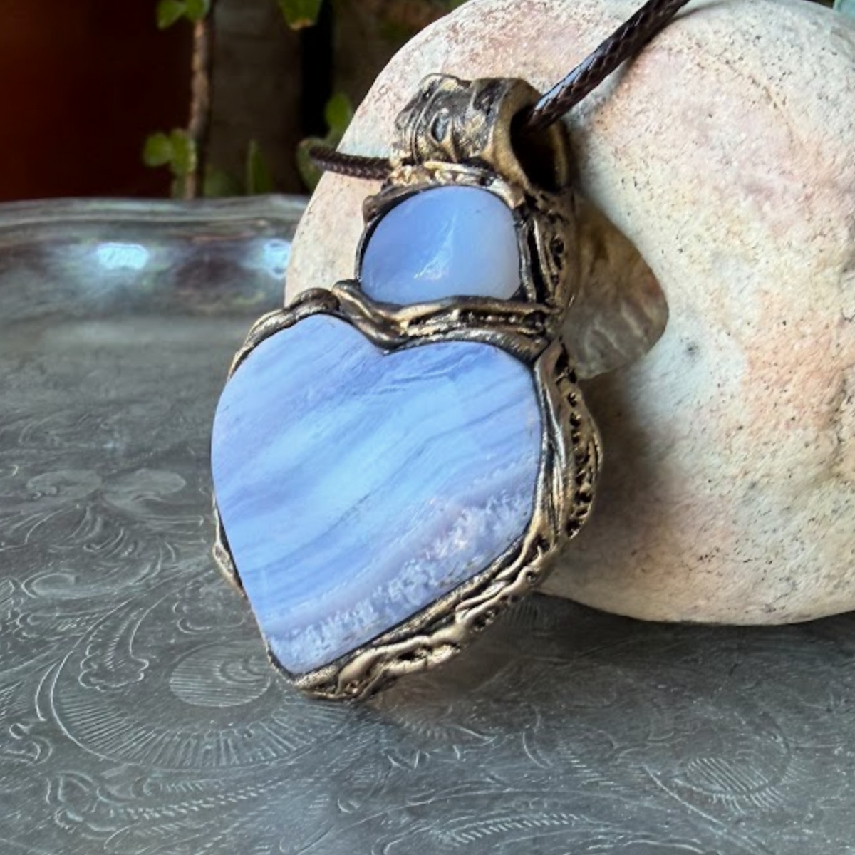 Heart stone pendant necklace with natural Blue Lace Agate and Chalcedony stones, handcrafted healing crystal amulet in soft blue tones.