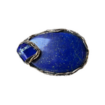 Oversized chunky lapis lazuli cocktail ring with large deep blue natural stone and bold statement design.