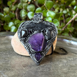 Sculptural heart pendant necklace with central purple Amethyst, dark textured setting and polished Hematite stones.