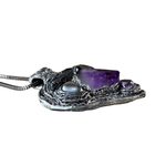 Sculptural heart pendant necklace with central purple Amethyst, dark textured setting and polished Hematite stones.