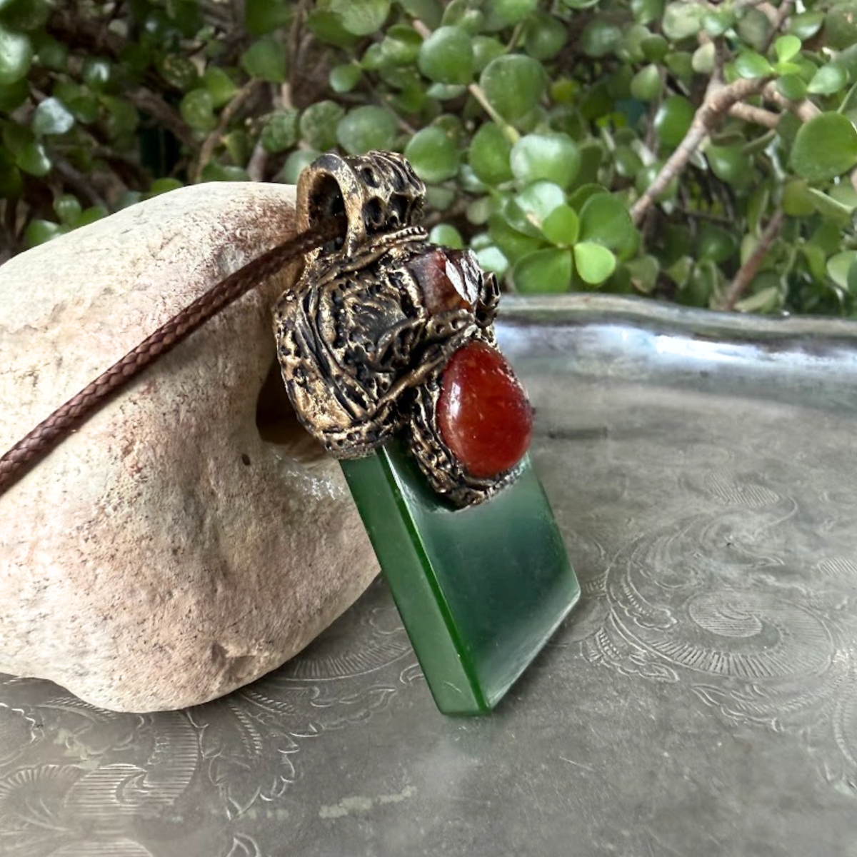 Large green Jade pendant necklace with red Carnelian stones in a handcrafted sculptural amulet setting.