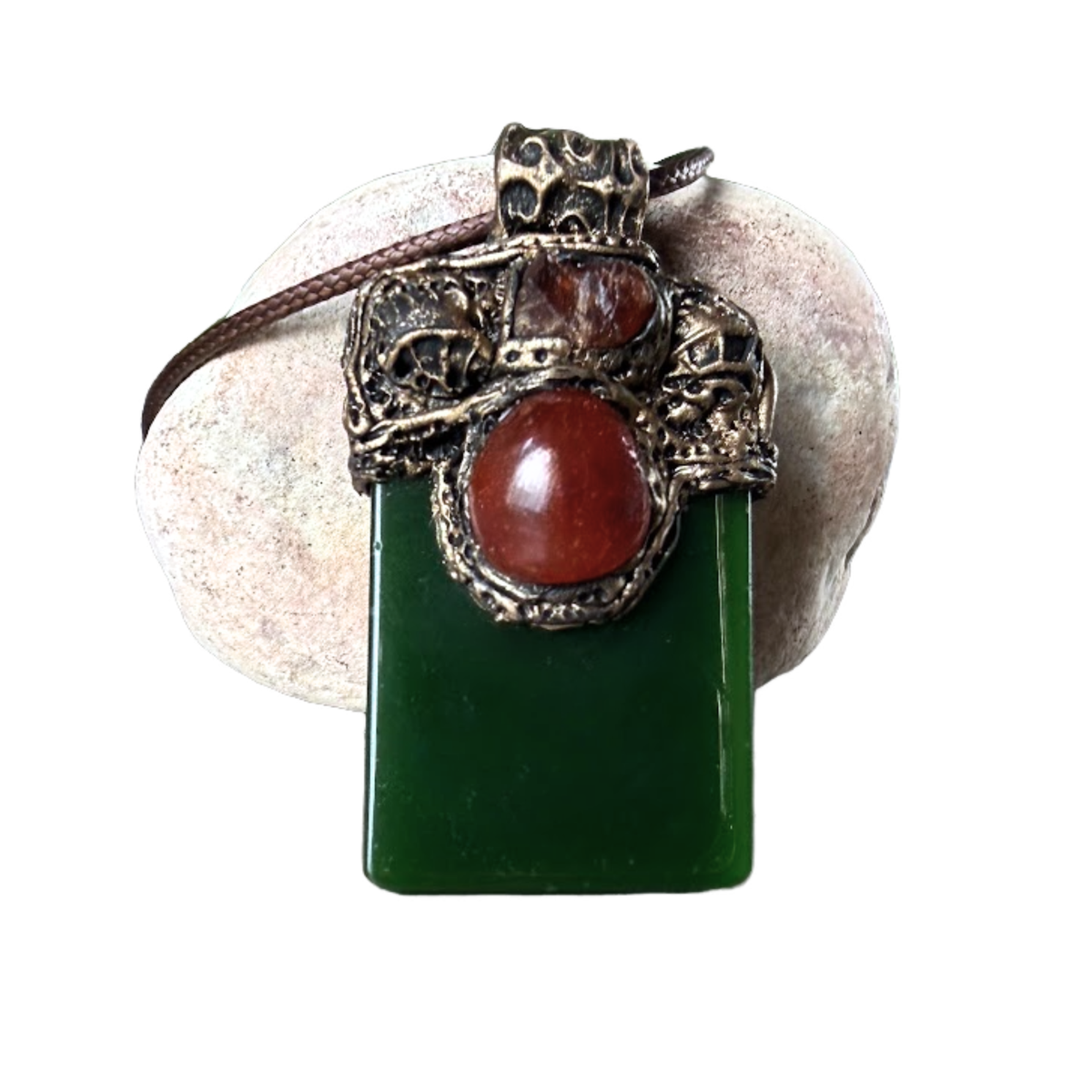 Large green Jade pendant necklace with red Carnelian stones in a handcrafted sculptural amulet setting.