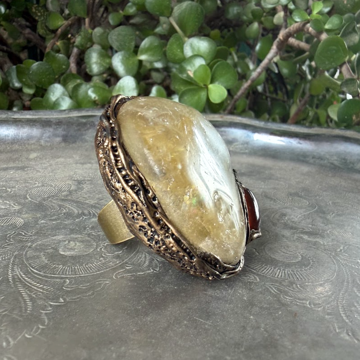 Oversized Citrine and Carnelian statement ring with a large pale yellow natural crystal and smaller reddish-brown stone in a sculptural setting.