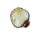 Oversized Citrine and Carnelian statement ring with a large pale yellow natural crystal and smaller reddish-brown stone in a sculptural setting.