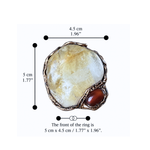 Oversized Citrine and Carnelian statement ring with a large pale yellow natural crystal and smaller reddish-brown stone in a sculptural setting.