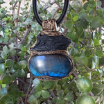 Large Labradorite and Black Kyanite pendant choker worn on a model, featuring raw black crystal above a polished blue-flash Labradorite in an ornate bronze-tone setting.