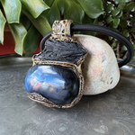 Large Labradorite and Black Kyanite pendant choker worn on a model, featuring raw black crystal above a polished blue-flash Labradorite in an ornate bronze-tone setting.