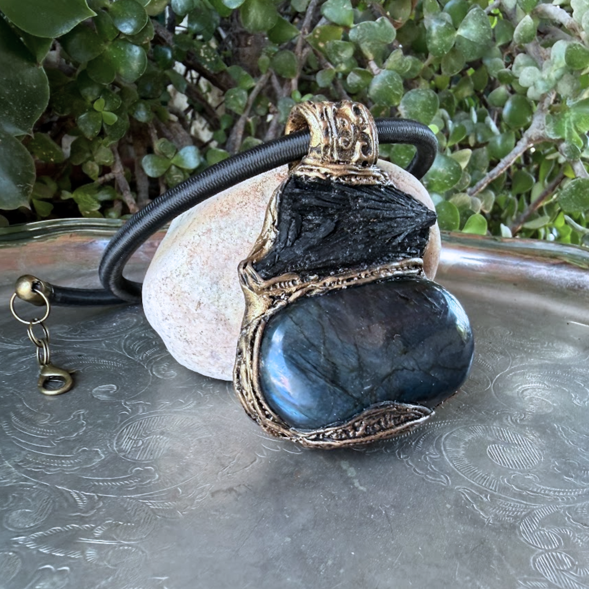 Large Labradorite and Black Kyanite pendant choker worn on a model, featuring raw black crystal above a polished blue-flash Labradorite in an ornate bronze-tone setting.