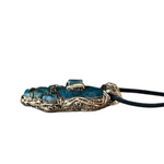 Handmade Blue Apatite pendant necklace combining raw and polished blue gemstones with contrasting textures in an ornate antique bronze-tone polymer clay setting on a black cord.