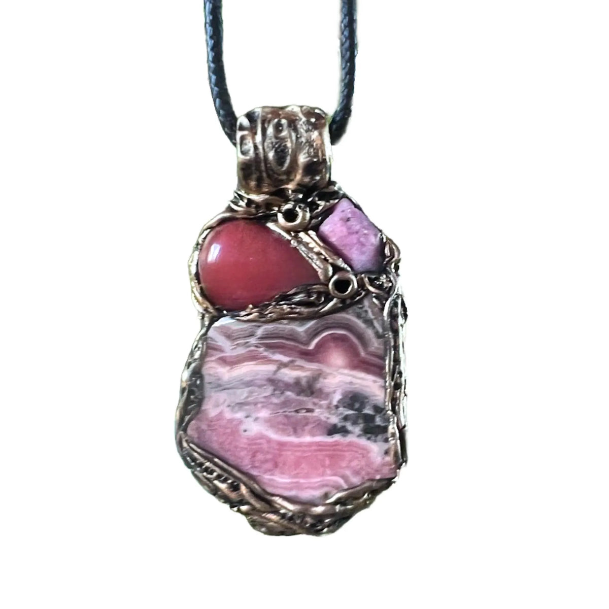 Handmade large pink crystal pendant necklace featuring Rhodochrosite, Ruby and Cherry Quartz gemstones in a sculptural one-of-a-kind love amulet design.