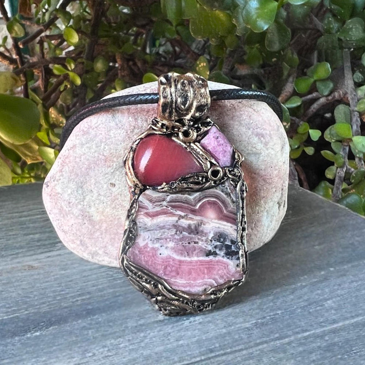 Handmade large pink crystal pendant necklace featuring Rhodochrosite, Ruby and Cherry Quartz gemstones in a sculptural one-of-a-kind love amulet design.