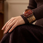 Wide statement cuff bracelet with an exceptionally large natural Sardonyx displaying red, rust, cream and white banded patterns.