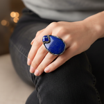 Oversized chunky lapis lazuli cocktail ring with large deep blue natural stone and bold statement design.