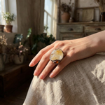 Oversized Citrine and Carnelian statement ring with a large pale yellow natural crystal and smaller reddish-brown stone in a sculptural setting.